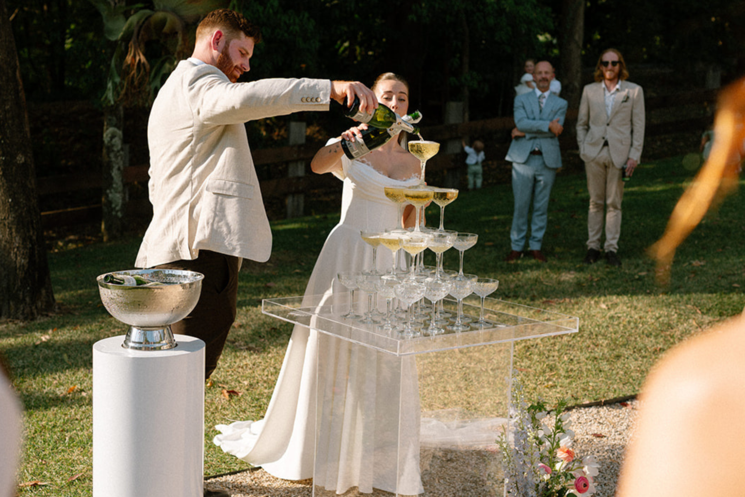 Couple pouring the champagne tower after the ceremony