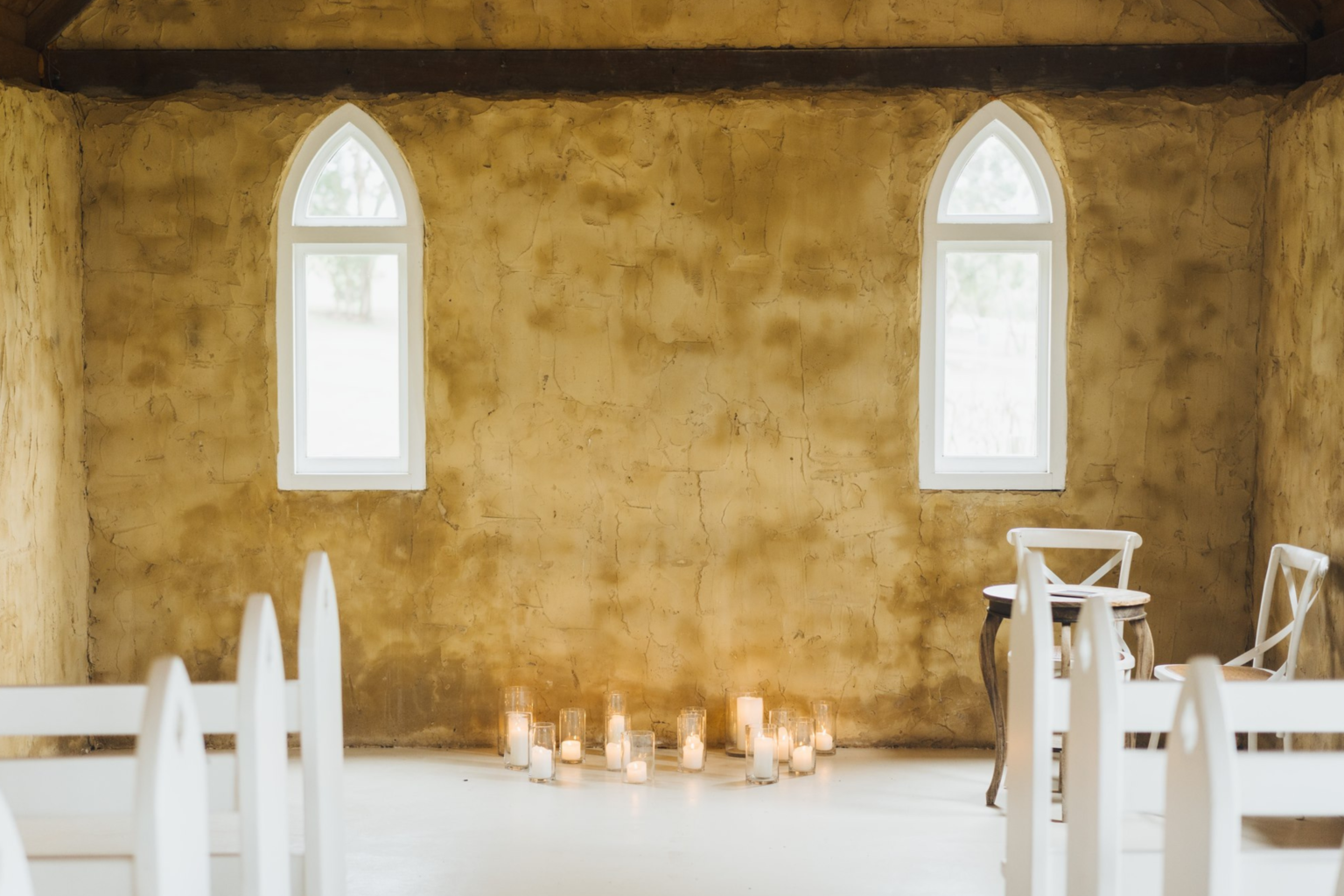 White pews and candles inside the Peppers Creek chapel