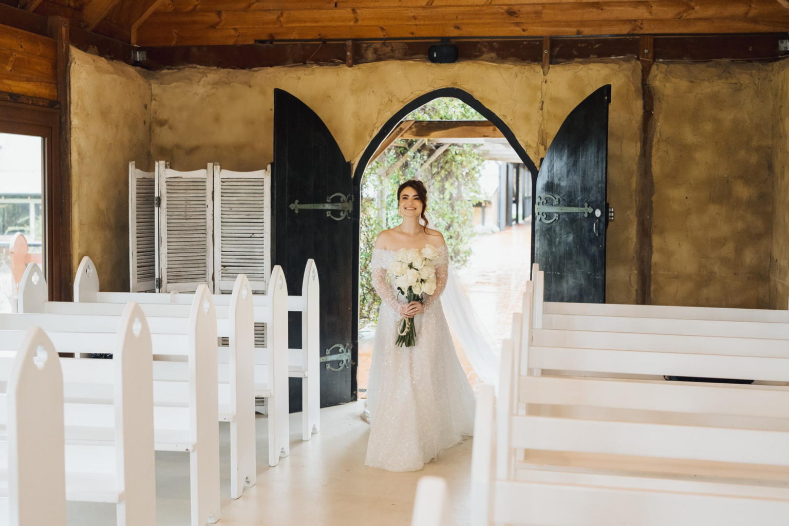 Bride entering the chapel through the timber doors