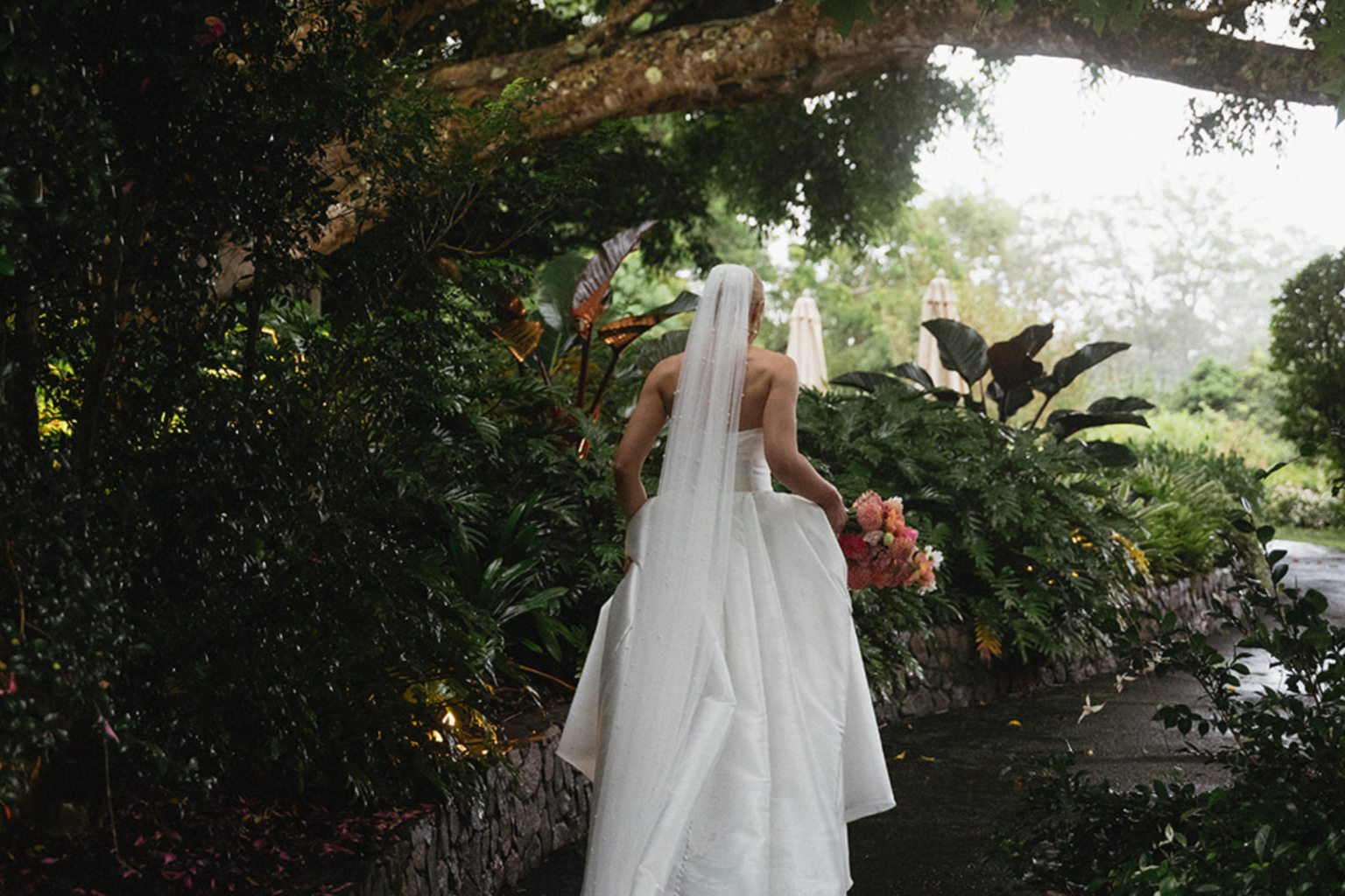 Bride walking through the tropical gardens