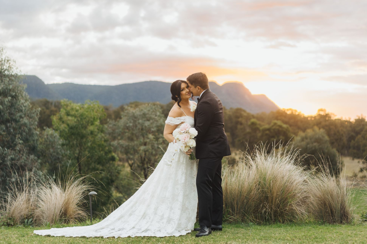 Couple kissing at sunset with mountain views at Spicers Guesthouse