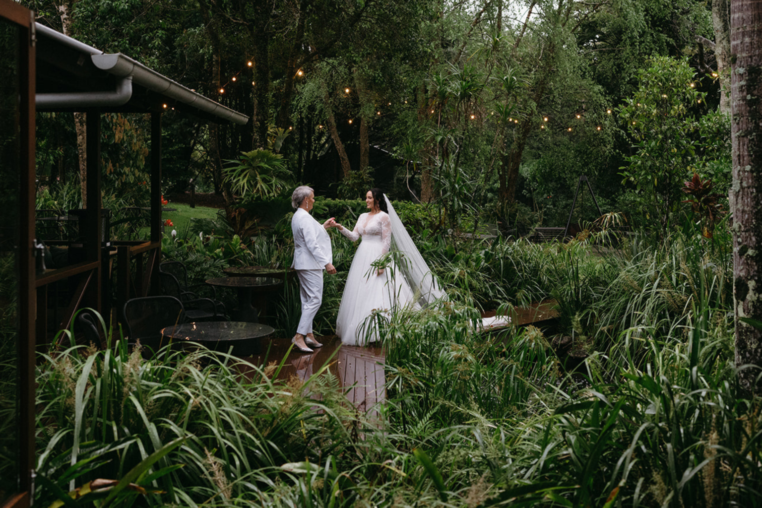 Couple near a villa surrounded by lush rainforest