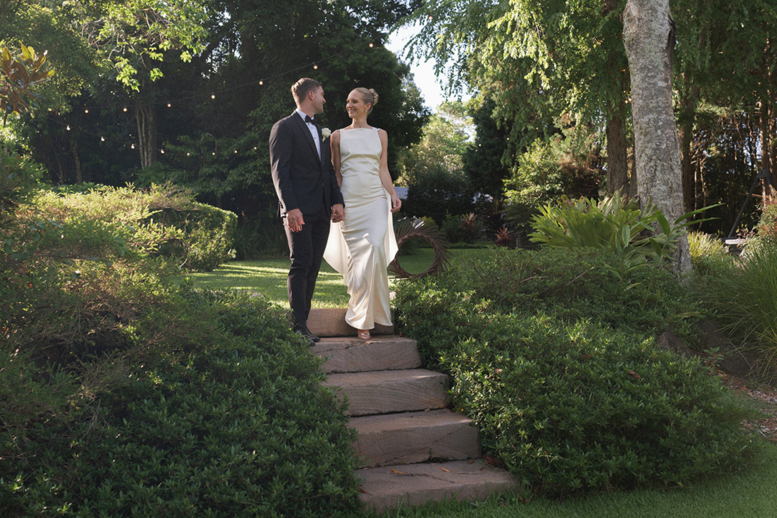 Couple descending stone garden steps at Spicers Tamarind Retreat