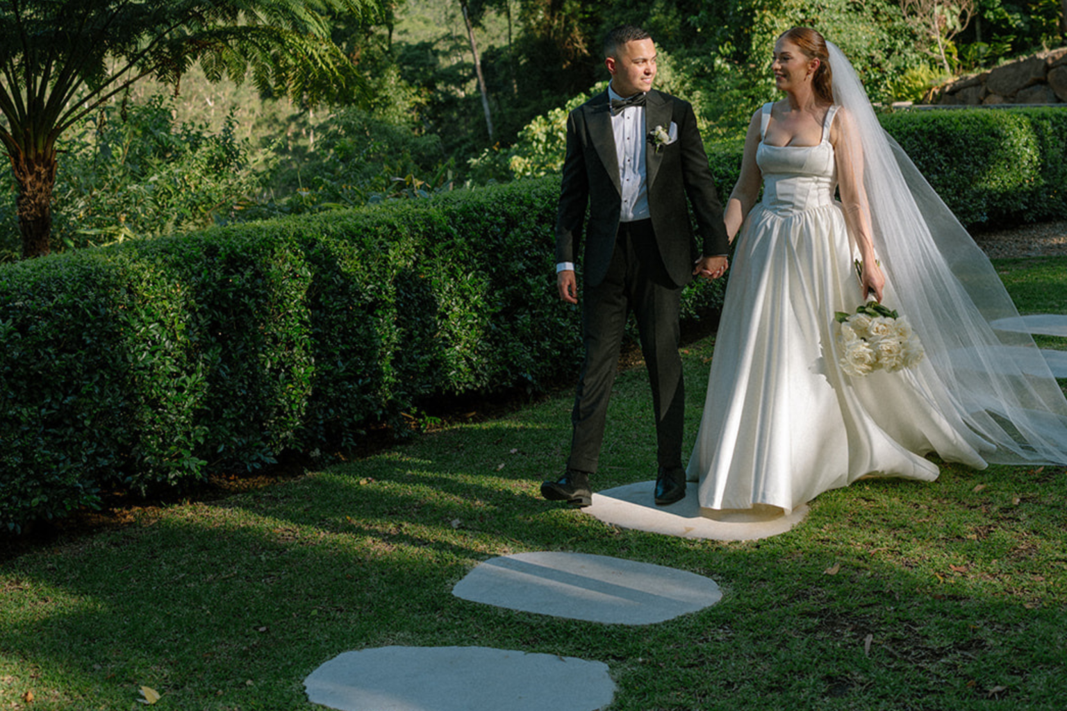 Bride and groom on the stepping-stone garden path