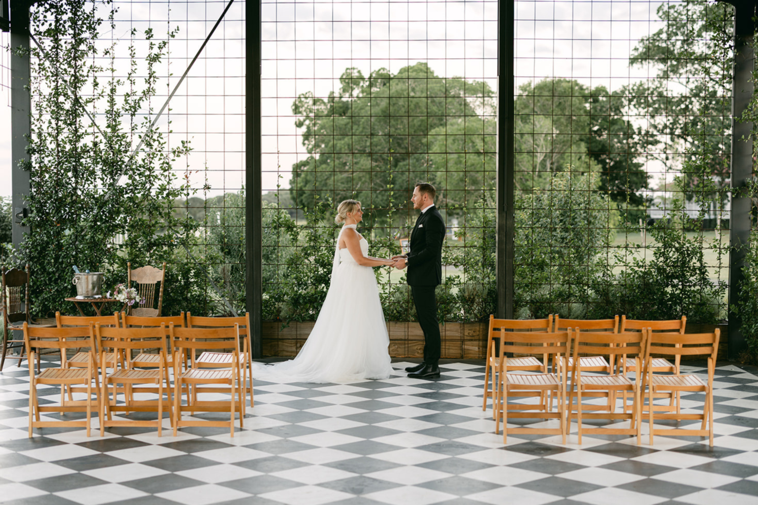 Bride and groom exchanging vows in the Conservatory at Twigley Farm